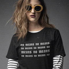 black feminist t-shirt that says no means no over and over in white tattoo style writing- shop feminist trash for women's march merchandise and feminist clothing