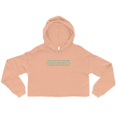 Peach feminist cropped hoodie featuring 'Seize the Day with the Unearned Confidence of a Mediocre White Man' text, empowering women to embrace their potential. Shop feminist apparel