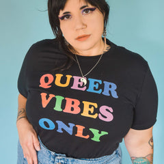 Pride t-shirt in black proclaiming "Queer Vibes Only" in rainbow writing