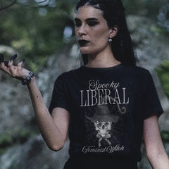 black feminist t shirt that says spooky liberal feminist witch in white writing- featuring a skull witch spider web watercolour style illustration. Shop feminist trash for witchy outfits and feminist t shirts