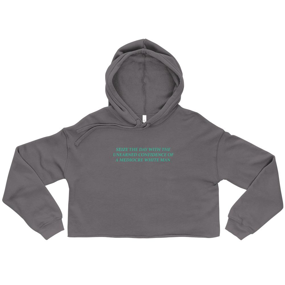 Storm (gray) feminist cropped hoodie with 'Seize the Day with the Unearned Confidence of a Mediocre White Man' text, empowering women to seize opportunities. Shop feminist apparel