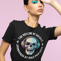 funny feminist tshirt that says the decline of society sponsored by male podcasts in white bold writing, featuring a digital watercolor style illustration of a skull wearing headphones. Shop feminist Trash for political clothing, feminist shirts and pride merch