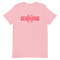 Image of a pink feminist t-shirt with 'Mansplainer Survivor' in bold red lettering. This feminist shirt is a powerful statement of resilience against gender discrimination. Add this feminist tshirt to your wardrobe today