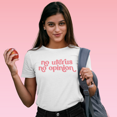 White feminist t-shirt boldly stating 'No Uterus No Opinion' in peach, advocating for reproductive rights and gender equality. Shop feminist apparel
