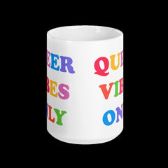15 0z Pride mug that says Queer Vibes in rainbow retro writing- shop feminist trash for pride clothing, political t shirts, feminist apparel and dump him shirts