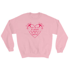 pink  feminist sweatshirt that says Don’t Care For The Patriarchy, The Monarchy Or This Fake Ass Democracy in red writing surrounded by angel cherubs holding guns- shop feminist sweatshirts and dump him shirts