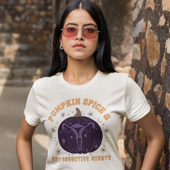 white feminist shirt that says pumpkin spice and reproductive rights in orange writing- featuring a purple pumpkin illustration with a uterus inside- shop feminist trash for halloween feminist tshirts and outfits for fall