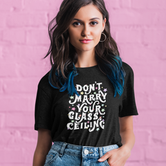 black feminist tee that says Don't Marry Your Glass Ceiling in white willy wonka writing surrounded by multicolour stars. Shop Feminist Trash Store for Women’s Rights T-shirts and women's march merchandise.