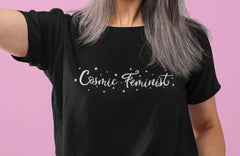 Black feminist tshirt that says Cosmic Feminist in white witchy writing surrounded by stars- Shop apparel, witchy outfits, political clothing, dump him shirts and outfits for pride.