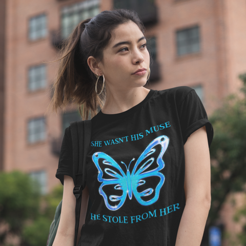 Black feminist  tshirt that says She Wasn’t His Muse. He Stole From Her in blue writing featuring a digital illustration of a butterfly- Shop feminist trash for feminist tees and dump him shirts