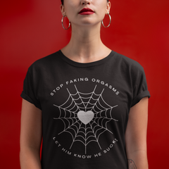 black feminist tee that says stop faking orgasms let him know he sucks in white writing featuring a heart spider web illustration- shop feminist trash for women's rights t-shirts and dump him shirts